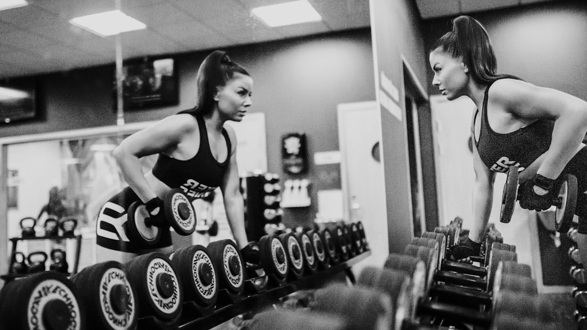 woman in black tank top and black shorts doing exercise