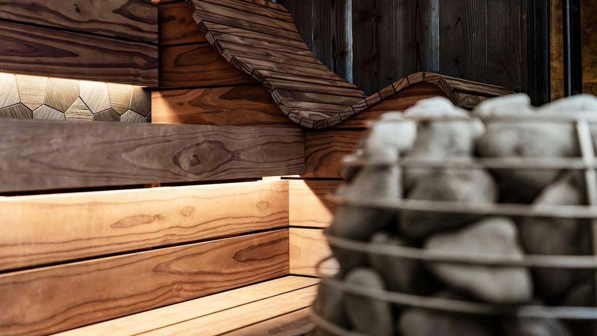 Wooden sauna interior with heater and ambient lighting